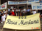 Demonstrators against Rumania's planned destruction of churches, cemeteries, homes and displacing an entire village to make room for one-mile-wide, open-pit cyanide mine.